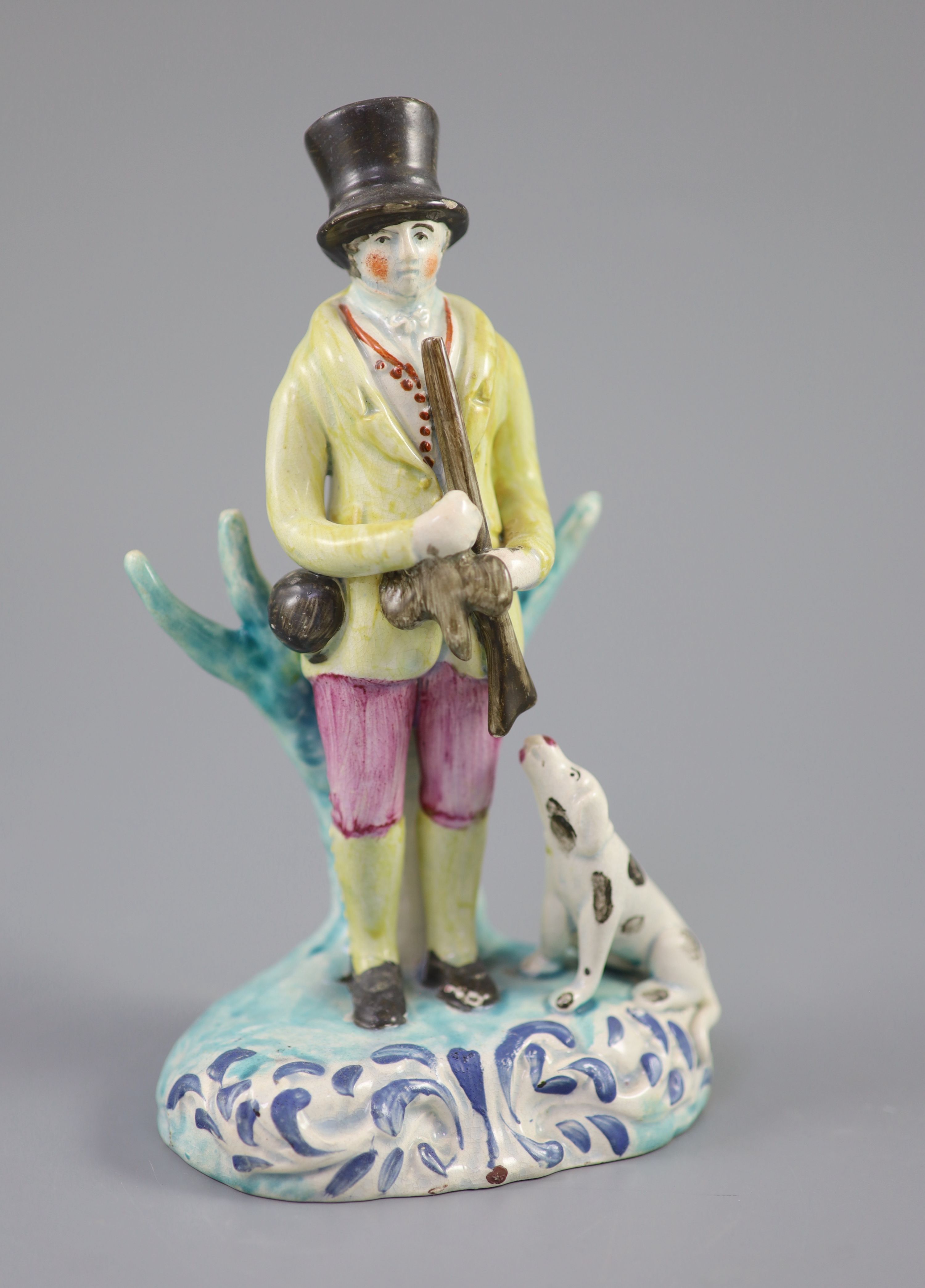 A Staffordshire pearlware group of a huntsman with dog and gun, c.1820-30, 18.5cm high